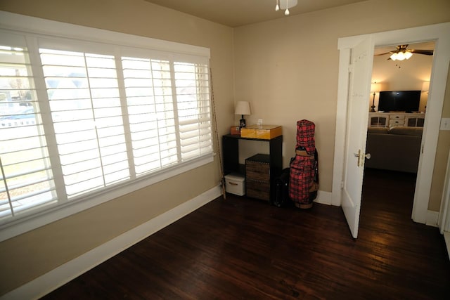 miscellaneous room with ceiling fan and dark wood-type flooring