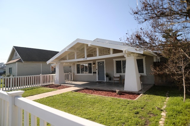 view of front of home with a porch and a front lawn