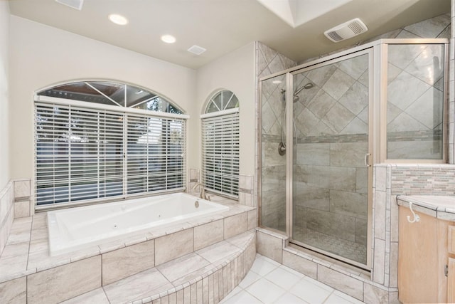 bathroom featuring tile patterned flooring, shower with separate bathtub, and vanity