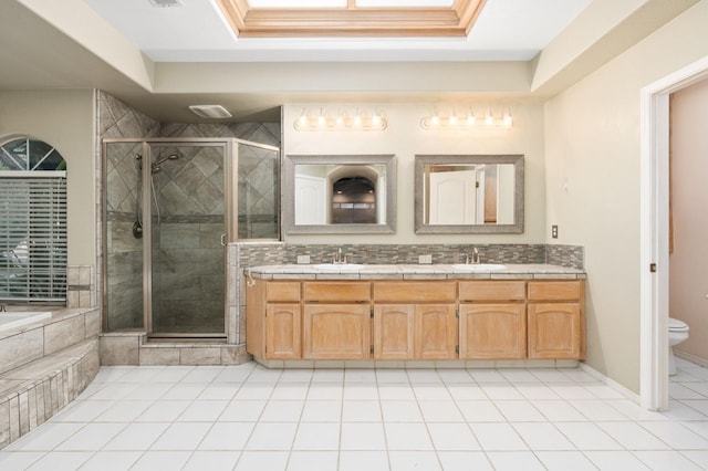 full bathroom featuring tile patterned flooring, vanity, separate shower and tub, and toilet