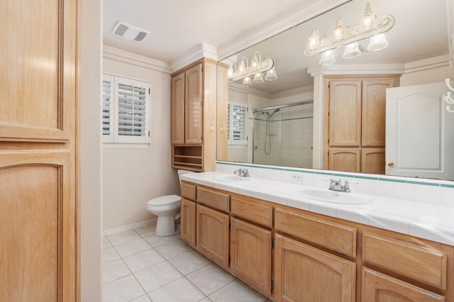 bathroom with tile patterned floors, vanity, an enclosed shower, and toilet