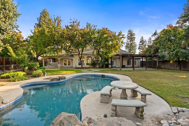 view of swimming pool featuring a yard and a patio