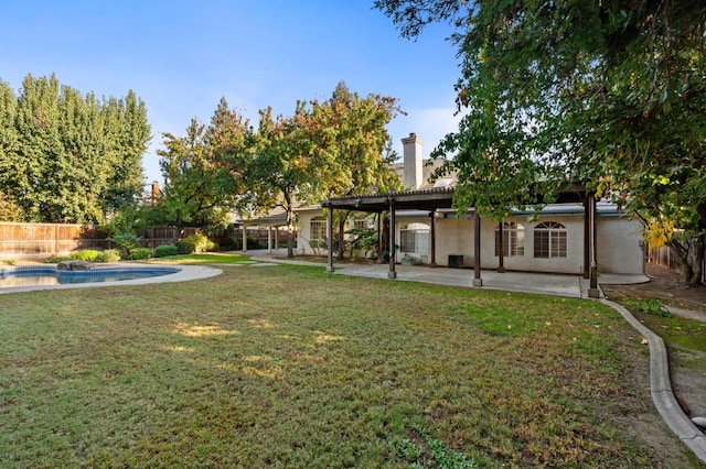 view of yard with a fenced in pool and a patio area