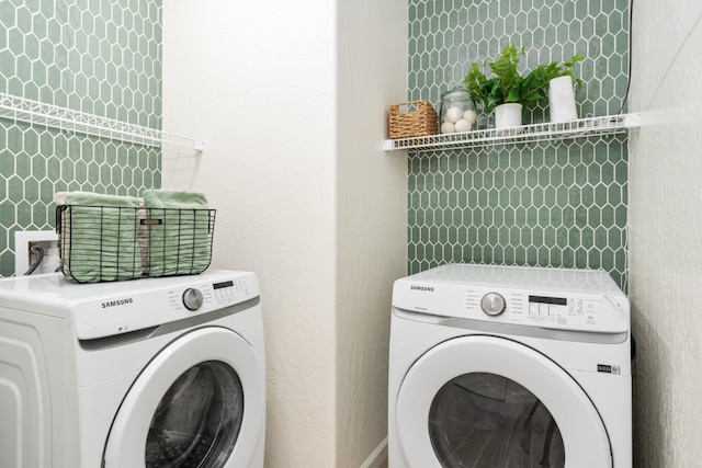 clothes washing area featuring laundry area and separate washer and dryer