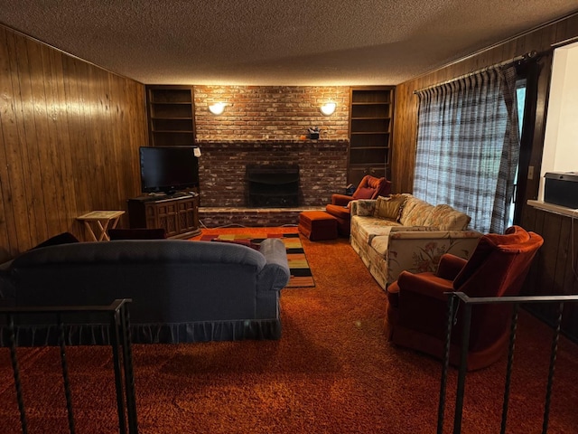 living area with built in shelves, carpet flooring, wood walls, and a textured ceiling