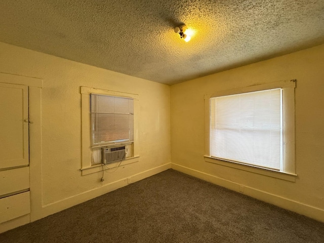 carpeted spare room featuring a textured ceiling and cooling unit