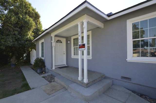 property entrance featuring covered porch