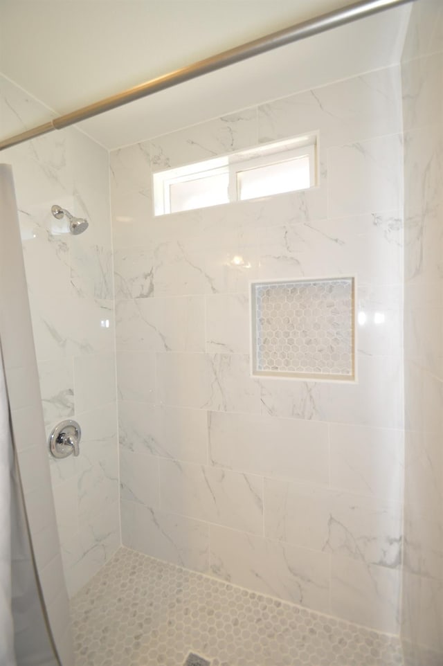 bathroom with a tile shower