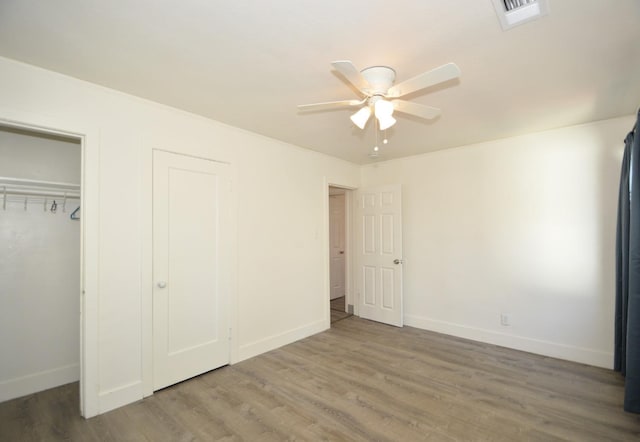 unfurnished bedroom with ceiling fan and wood-type flooring