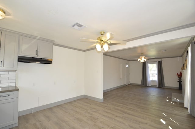 unfurnished living room with light wood-type flooring, ceiling fan, and ornamental molding