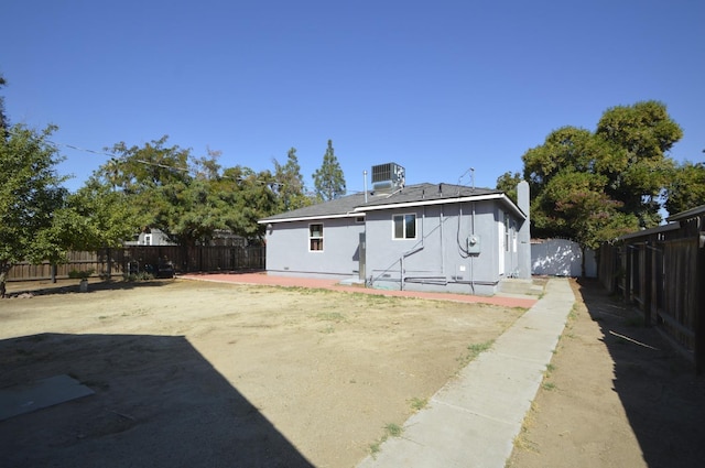 back of property featuring cooling unit and a patio