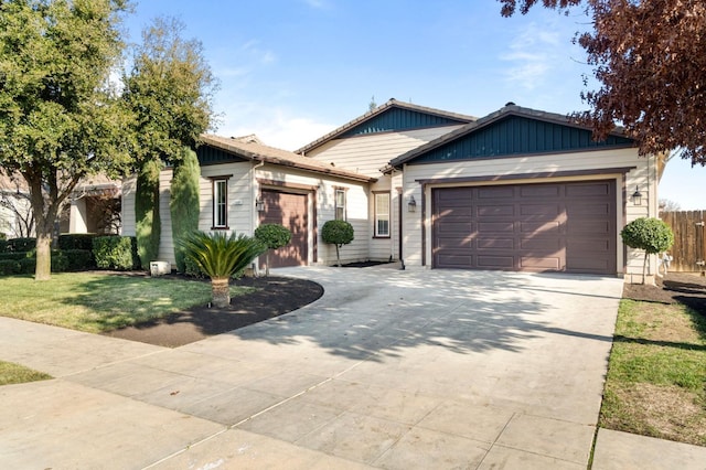 view of front of house featuring a garage and a front lawn