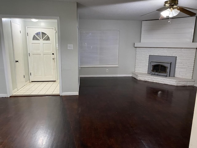 foyer entrance with a textured ceiling, hardwood / wood-style flooring, and ceiling fan