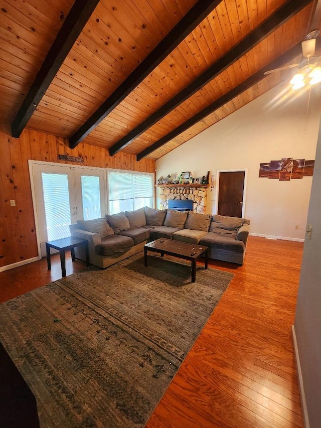 living room featuring hardwood / wood-style floors, vaulted ceiling with beams, ceiling fan, and wooden ceiling