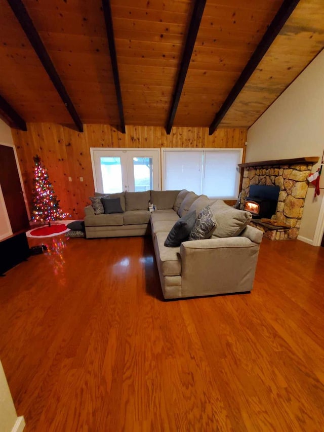 unfurnished living room featuring lofted ceiling with beams, wooden ceiling, and wood-type flooring