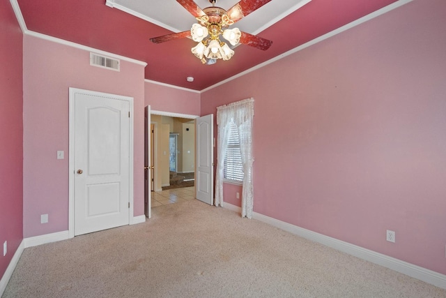 unfurnished bedroom with ceiling fan, crown molding, and light carpet