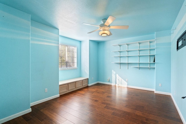 unfurnished room featuring ceiling fan and dark hardwood / wood-style flooring