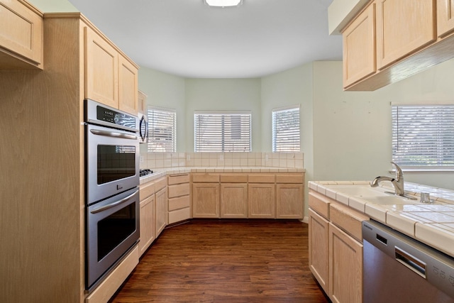 kitchen with tile countertops, sink, light brown cabinetry, and appliances with stainless steel finishes