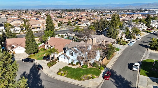 birds eye view of property with a mountain view