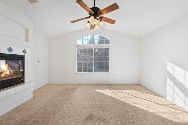 unfurnished living room with a fireplace, light carpet, vaulted ceiling, and ceiling fan