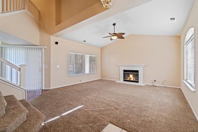 unfurnished living room with a healthy amount of sunlight, carpet floors, and a ceiling fan