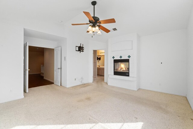 unfurnished living room with visible vents, baseboards, ceiling fan, a multi sided fireplace, and carpet
