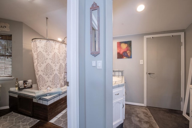 bathroom featuring vanity and vaulted ceiling
