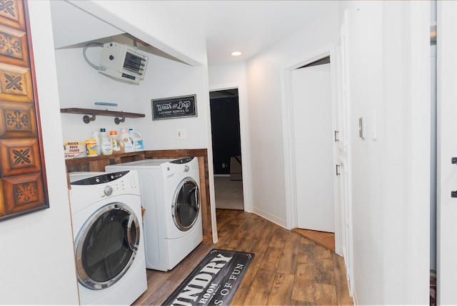 laundry room featuring heating unit, dark wood-type flooring, and independent washer and dryer