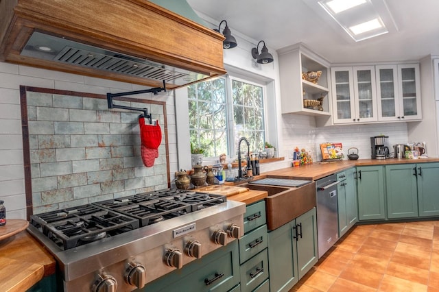kitchen featuring appliances with stainless steel finishes, tasteful backsplash, premium range hood, butcher block countertops, and white cabinetry