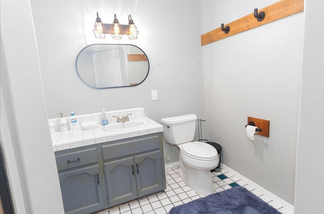 bathroom featuring tile patterned floors, vanity, and toilet