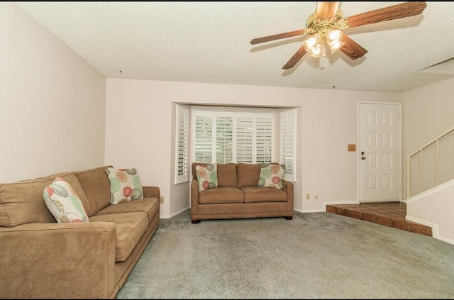 carpeted living room with ceiling fan and a textured ceiling