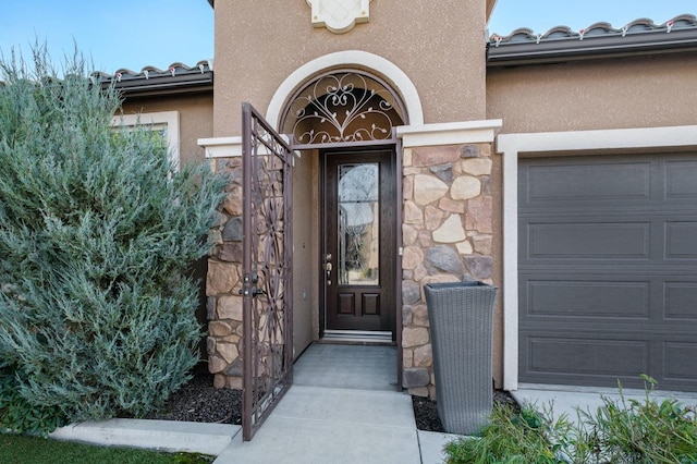 doorway to property with a garage