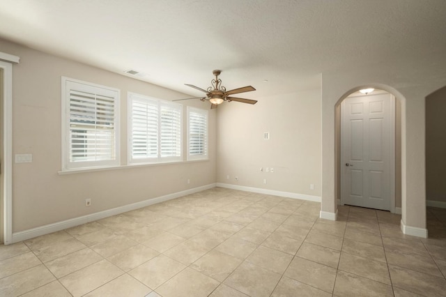 empty room featuring ceiling fan and light tile patterned flooring