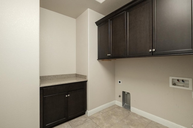 clothes washing area with washer hookup, hookup for an electric dryer, cabinets, and light tile patterned floors