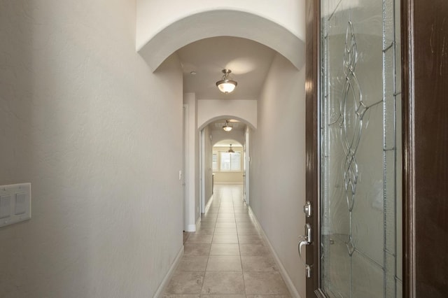 hall featuring light tile patterned flooring