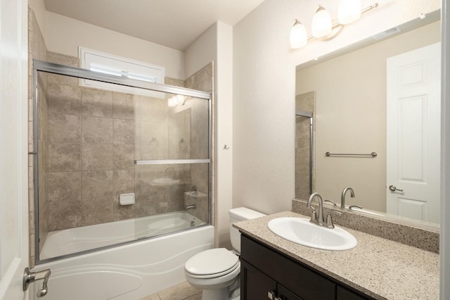 full bathroom with tile patterned flooring, toilet, combined bath / shower with glass door, and vanity