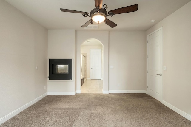 carpeted spare room with ceiling fan