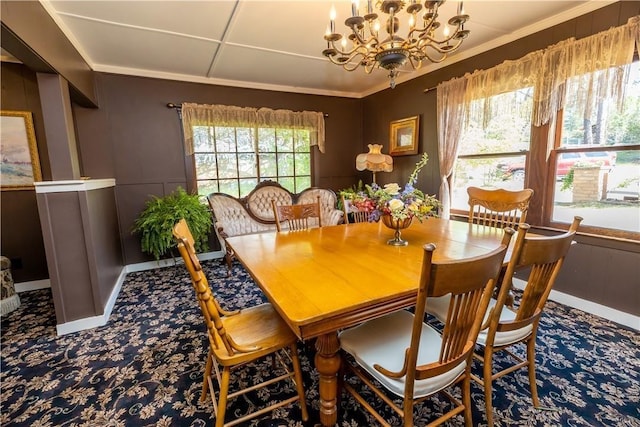 dining room featuring a chandelier, ornamental molding, and baseboards