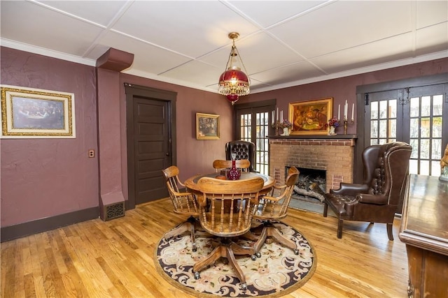 dining space featuring a healthy amount of sunlight, light wood finished floors, and french doors