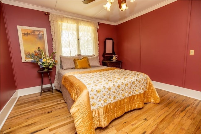 bedroom featuring ornamental molding, wood finished floors, a ceiling fan, and baseboards