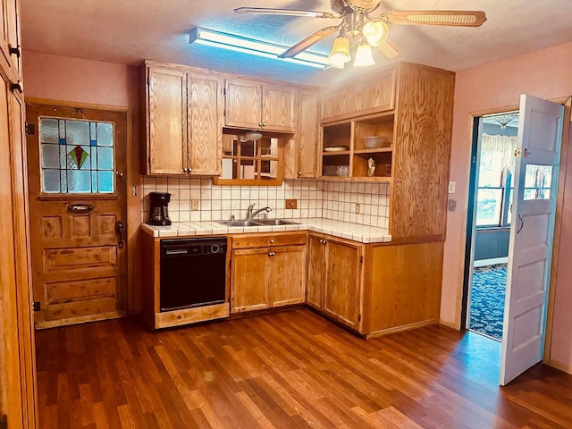 kitchen with a sink, dark wood-style floors, tile countertops, and dishwasher