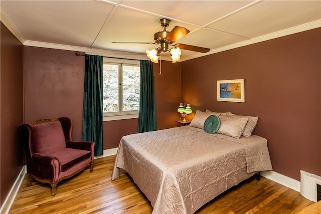 bedroom with ornamental molding, ceiling fan, baseboards, and wood finished floors