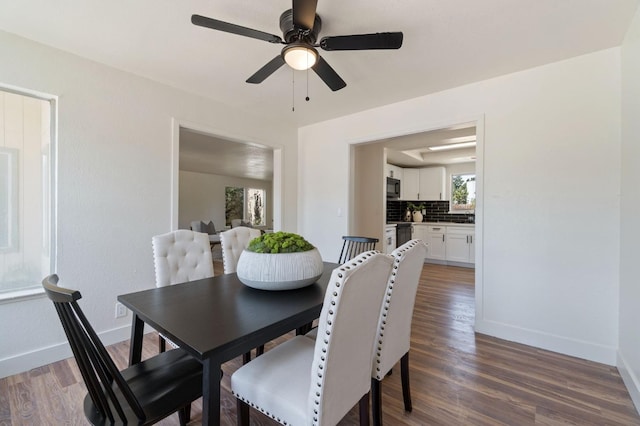 dining space with dark hardwood / wood-style flooring and ceiling fan