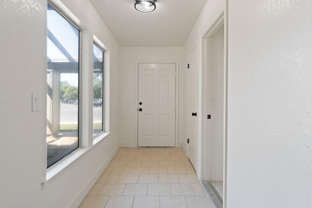 doorway to outside featuring light tile patterned floors