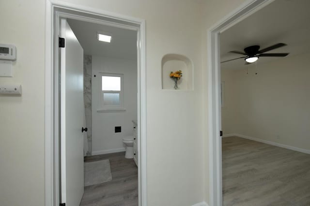 corridor with light hardwood / wood-style flooring