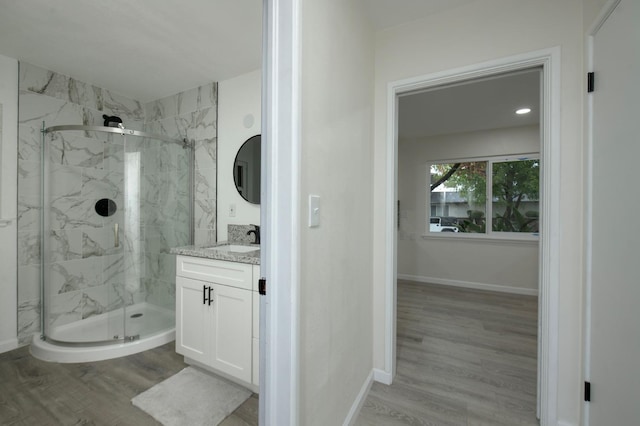 bathroom featuring vanity, hardwood / wood-style flooring, and walk in shower