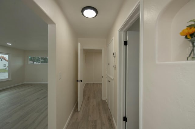 corridor with light hardwood / wood-style floors