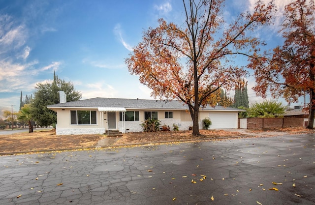 ranch-style home featuring a garage