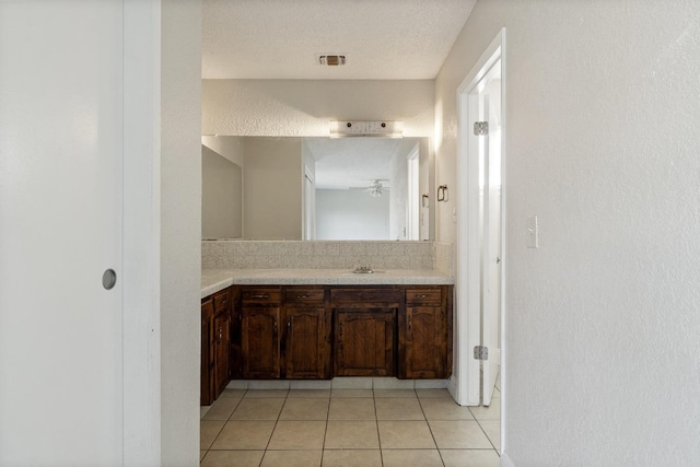 bathroom featuring vanity, tile patterned floors, ceiling fan, and a textured ceiling