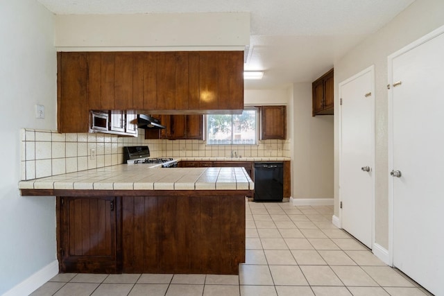 kitchen with kitchen peninsula, tile counters, exhaust hood, black appliances, and backsplash